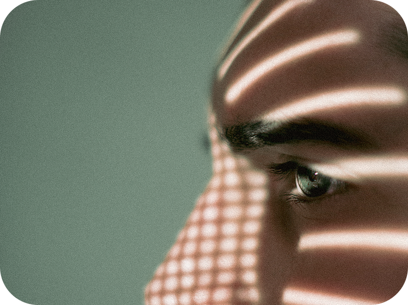 close-up-thoughtful-serious-young-man-looking-away-against-wall-1