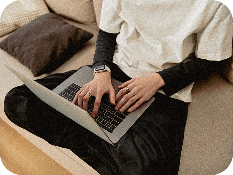 cozy-young-man-comfortably-typing-laptop-while-relaxing-home-relaxed-attire